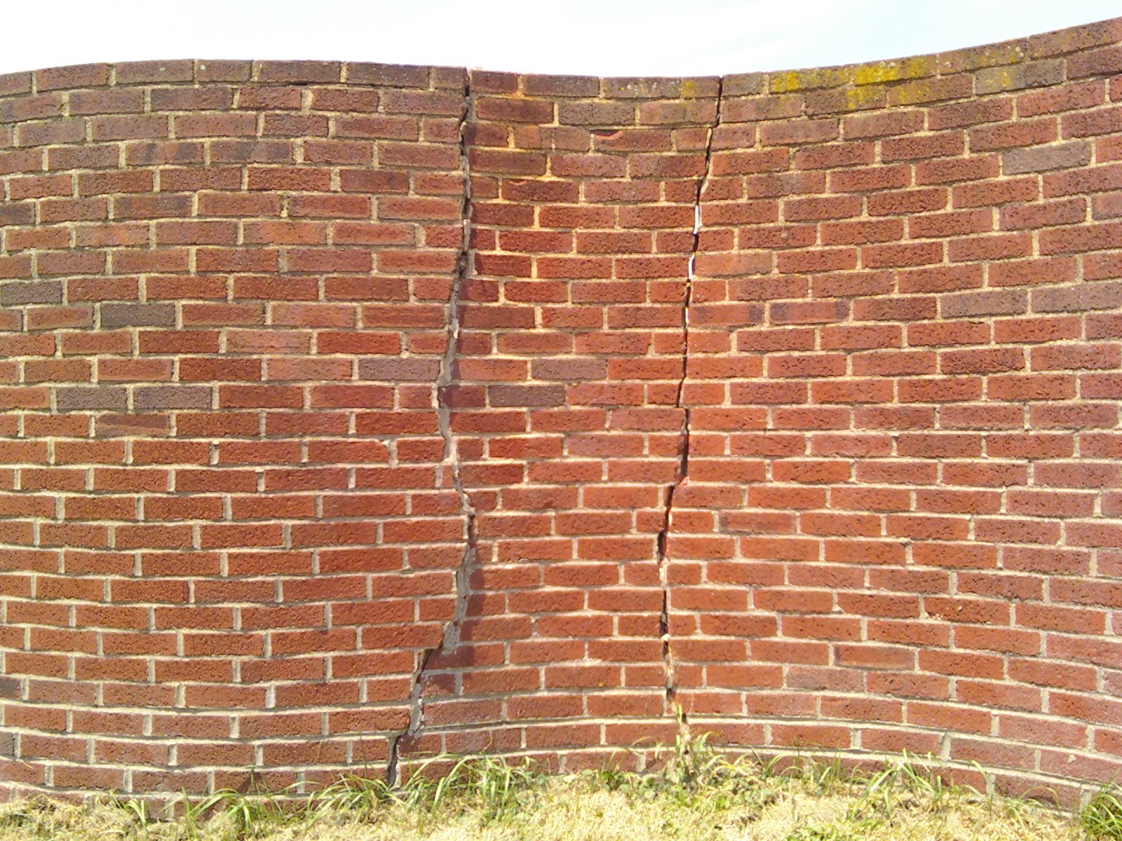 A stair-step crack running through a brick wall